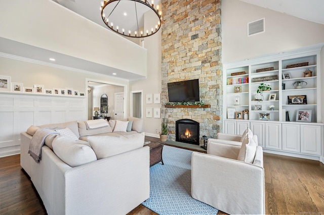 living room featuring visible vents, dark wood finished floors, crown molding, a fireplace, and high vaulted ceiling