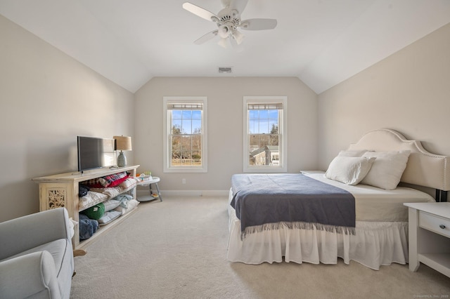 bedroom featuring vaulted ceiling, baseboards, a ceiling fan, and light colored carpet