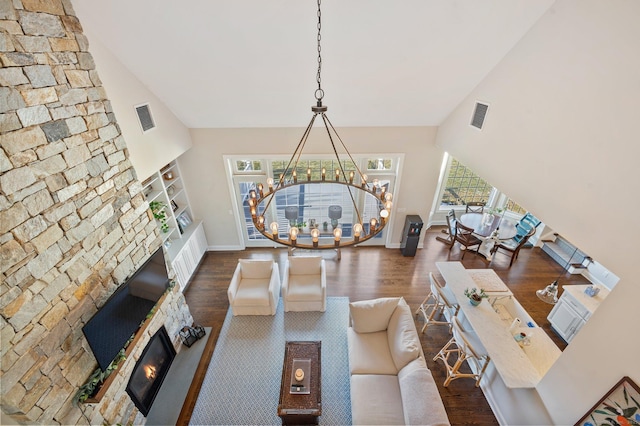 living area with baseboards, a fireplace, visible vents, and dark wood-type flooring