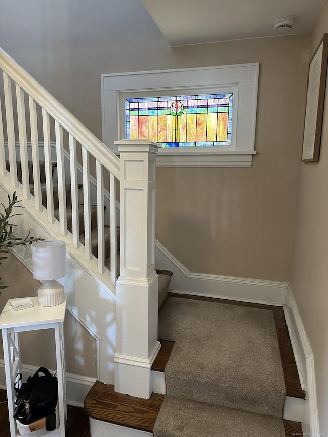 staircase featuring baseboards