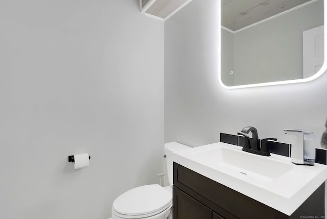 half bath with vanity and toilet