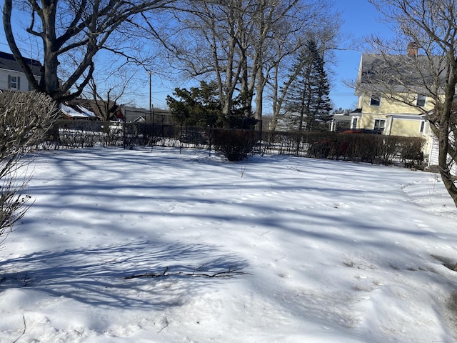 yard layered in snow featuring fence