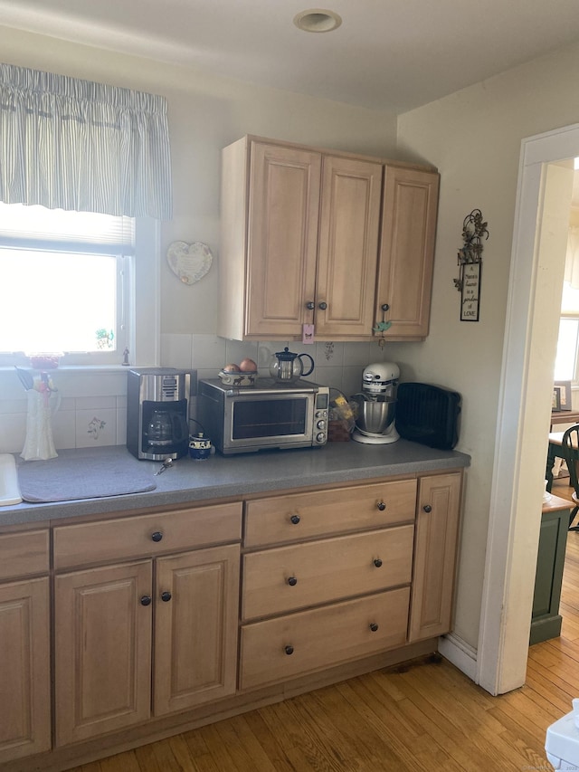 kitchen featuring a toaster, light brown cabinets, and light wood-style flooring