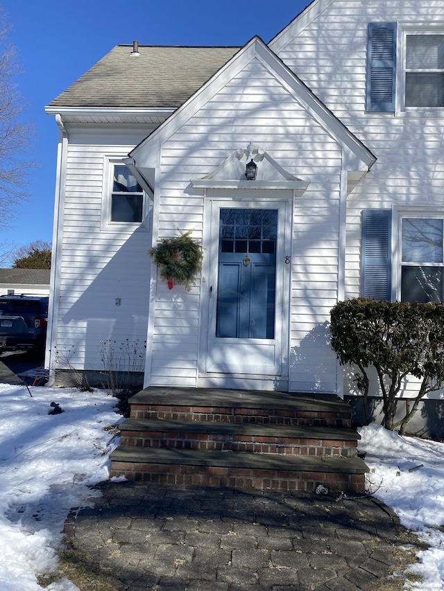 view of snow covered property entrance