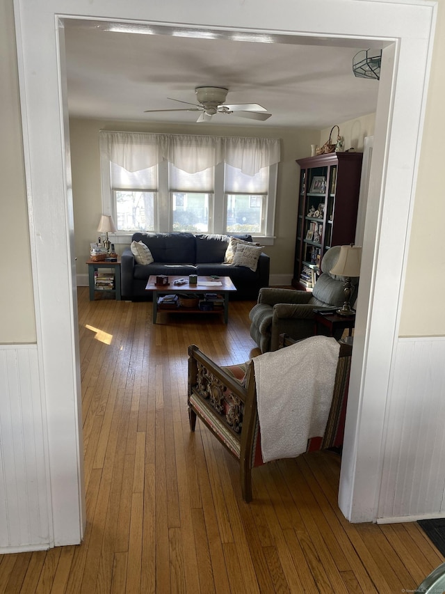 living room with ceiling fan, radiator heating unit, and wood finished floors