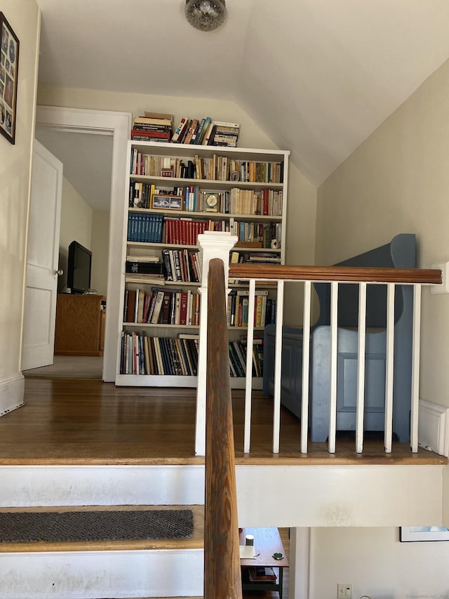 stairway with lofted ceiling and wood finished floors