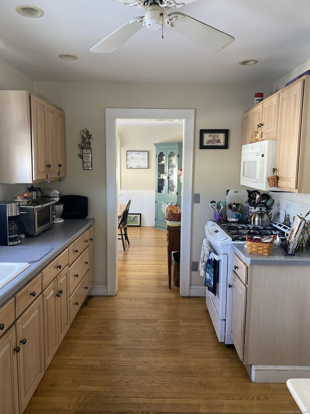 kitchen featuring light wood-type flooring, white appliances, and light brown cabinetry