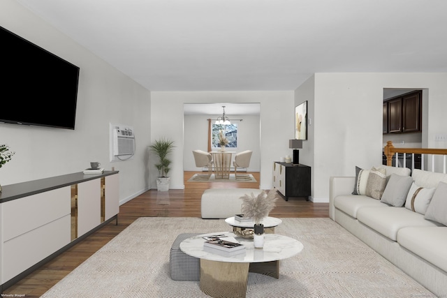 living area with a notable chandelier, baseboards, and wood finished floors