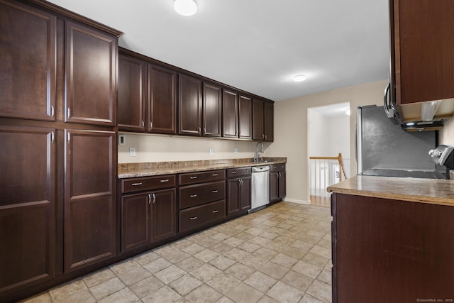 kitchen with stainless steel appliances, a sink, baseboards, dark brown cabinets, and light countertops