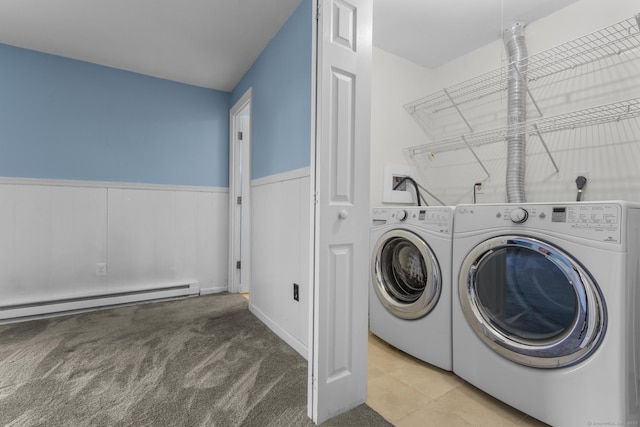 laundry room featuring a baseboard heating unit, laundry area, carpet floors, wainscoting, and washer and clothes dryer