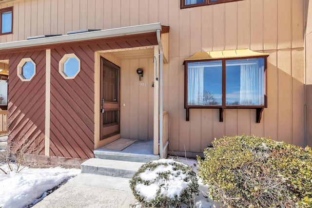 view of snow covered property entrance