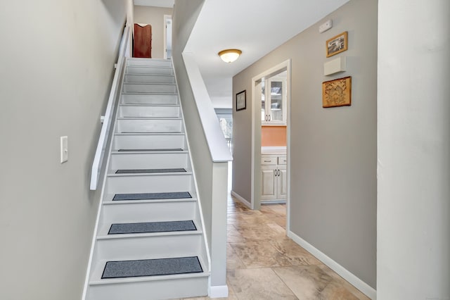 staircase featuring baseboards