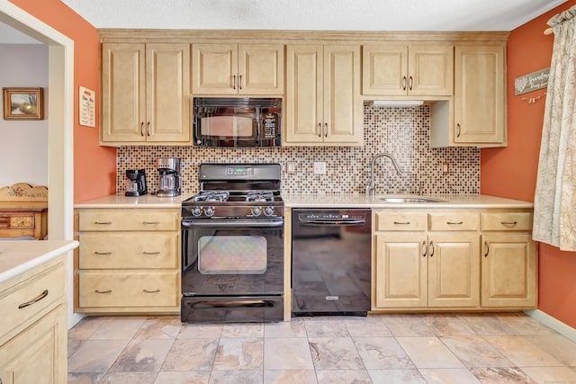 kitchen featuring decorative backsplash, light countertops, a sink, and black appliances