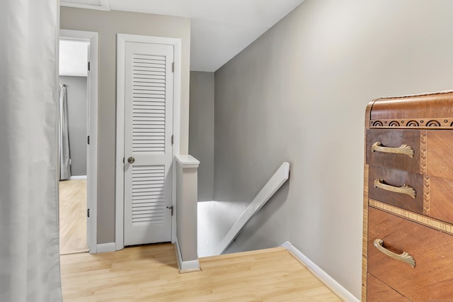 stairway with baseboards and wood finished floors