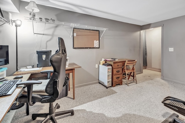 home office with light carpet and baseboards