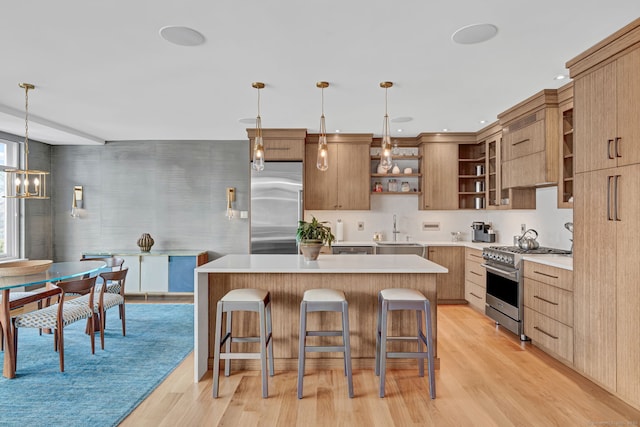 kitchen featuring open shelves, premium appliances, a kitchen island, and a sink