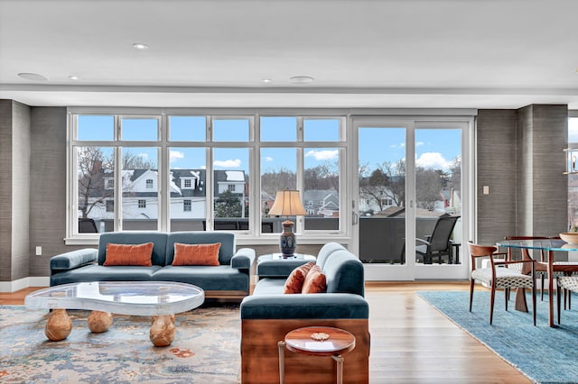 living area with baseboards and light wood finished floors