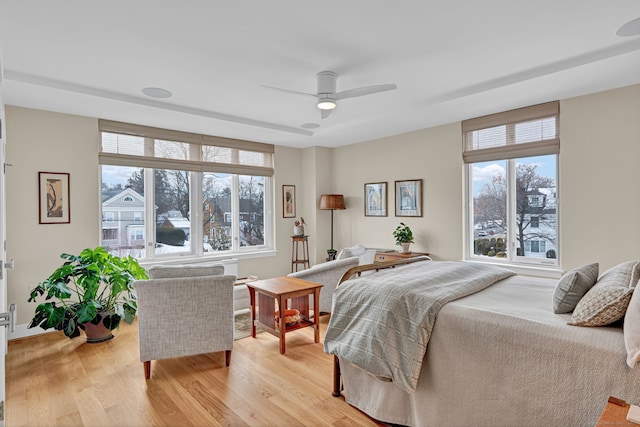 bedroom with light wood-type flooring and ceiling fan