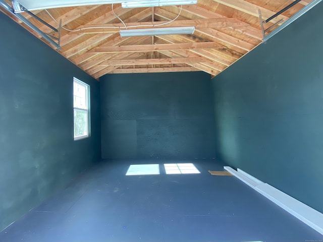 unfurnished room featuring lofted ceiling