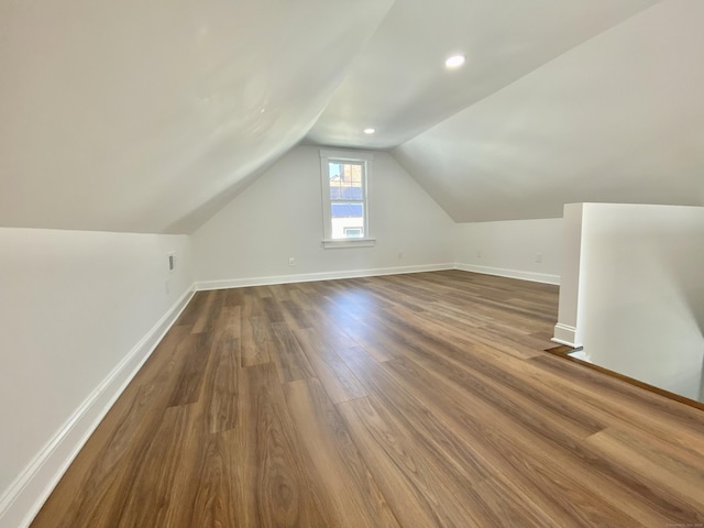 bonus room with recessed lighting, baseboards, dark wood-style floors, and lofted ceiling