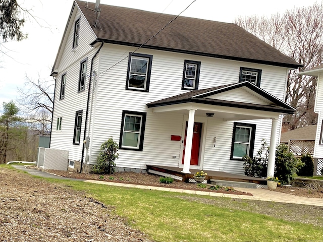 view of front of house featuring a shingled roof and a porch