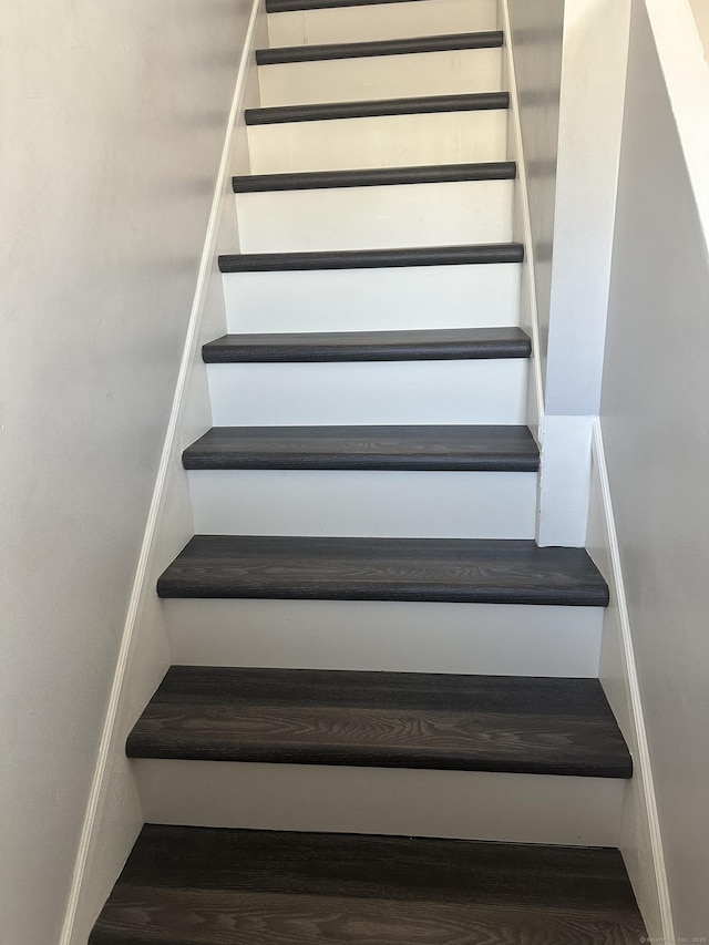 stairway with wood finished floors