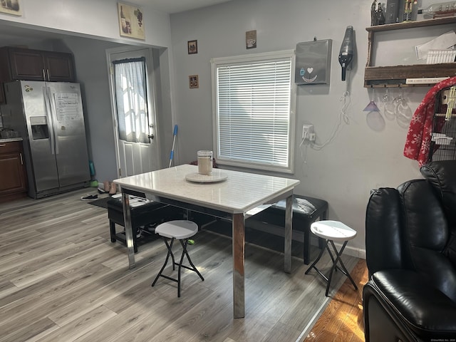 dining room with baseboards and light wood finished floors