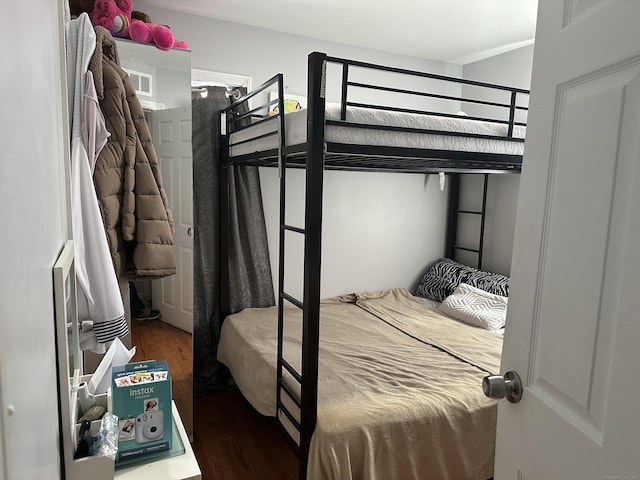 bedroom with dark wood finished floors and visible vents