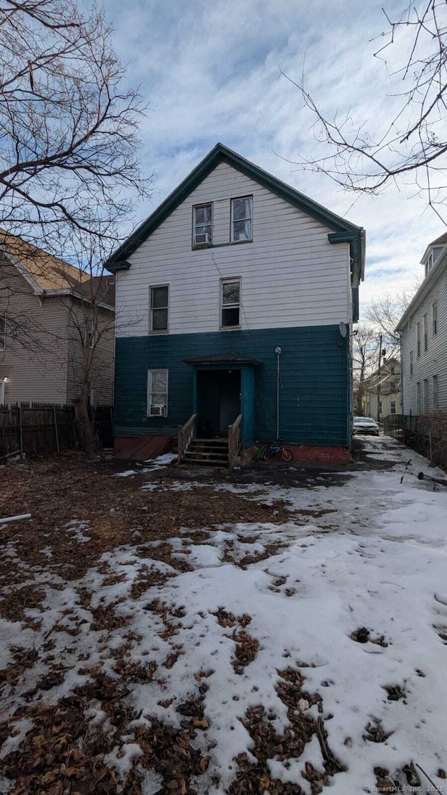 view of front of property featuring entry steps and fence