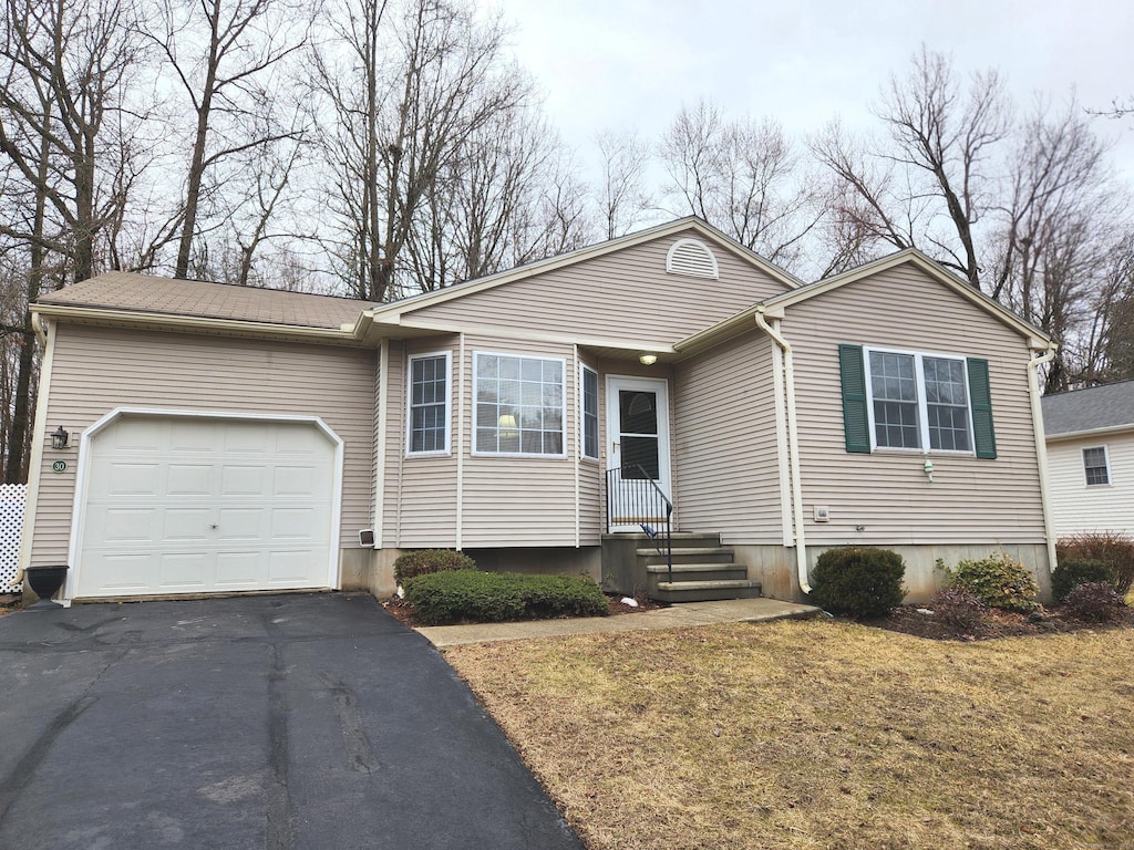 single story home featuring a garage and driveway