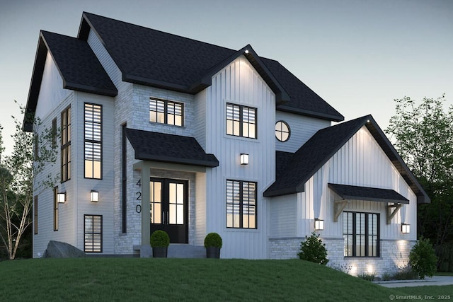 277 N Granby Rd, Granby, CT 06035 - modern farmhouse style home featuring board and batten siding, roof with shingles, a front lawn, french doors, and stone siding