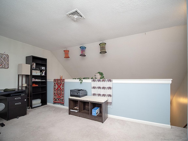 recreation room with baseboards, visible vents, a textured ceiling, and light colored carpet