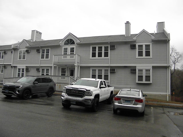 multi unit property featuring uncovered parking and a chimney