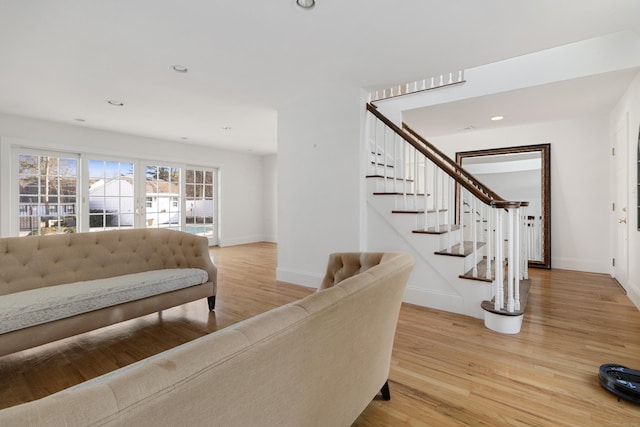 living area with baseboards, stairway, wood finished floors, and recessed lighting