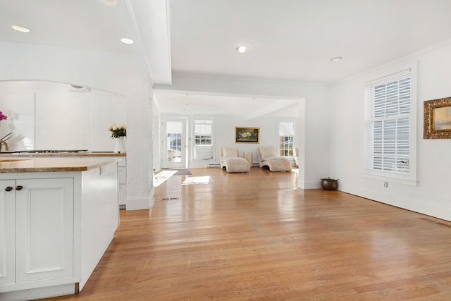 interior space with light wood-type flooring, beam ceiling, baseboards, and recessed lighting