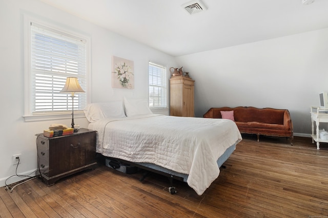 bedroom featuring baseboards, visible vents, and hardwood / wood-style floors