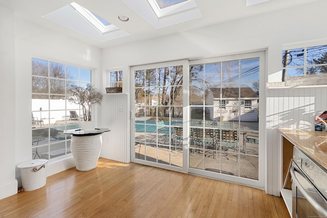 doorway featuring light wood-type flooring and a skylight