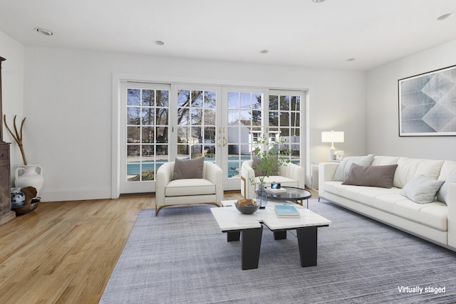 living area featuring recessed lighting, baseboards, and wood finished floors