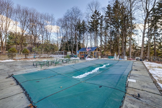 community pool featuring a patio and fence