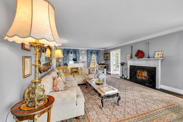 living room with baseboards, a premium fireplace, and crown molding