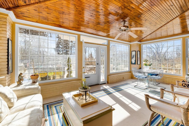 sunroom with lofted ceiling, wood ceiling, and ceiling fan