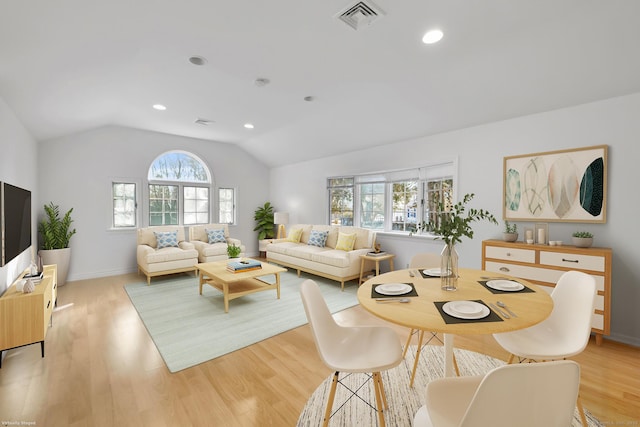 living room with lofted ceiling, visible vents, light wood-style flooring, and recessed lighting