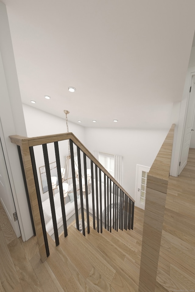stairs featuring recessed lighting and wood finished floors