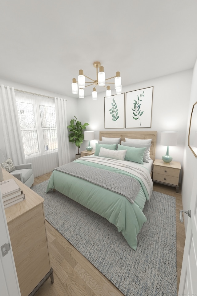 bedroom with a chandelier and wood finished floors