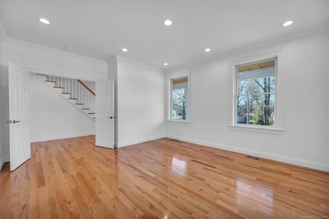 unfurnished living room with baseboards, visible vents, light wood finished floors, and a healthy amount of sunlight