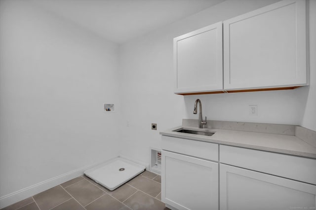 clothes washing area featuring light tile patterned floors, hookup for an electric dryer, washer hookup, a sink, and cabinet space