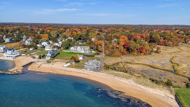 aerial view featuring a view of the beach, a water view, and a wooded view