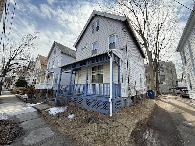 view of front of home with a residential view and a porch