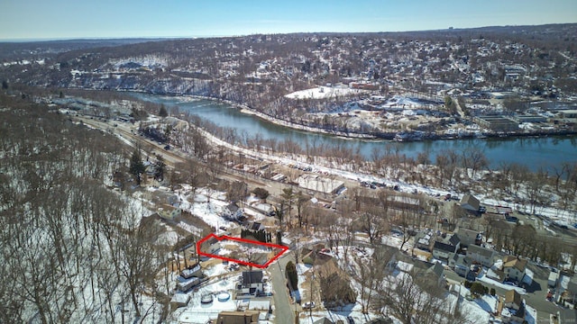 snowy aerial view with a water view