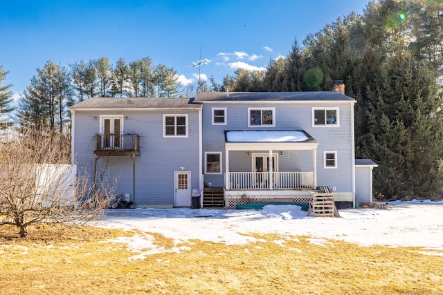 rear view of property featuring french doors and a chimney